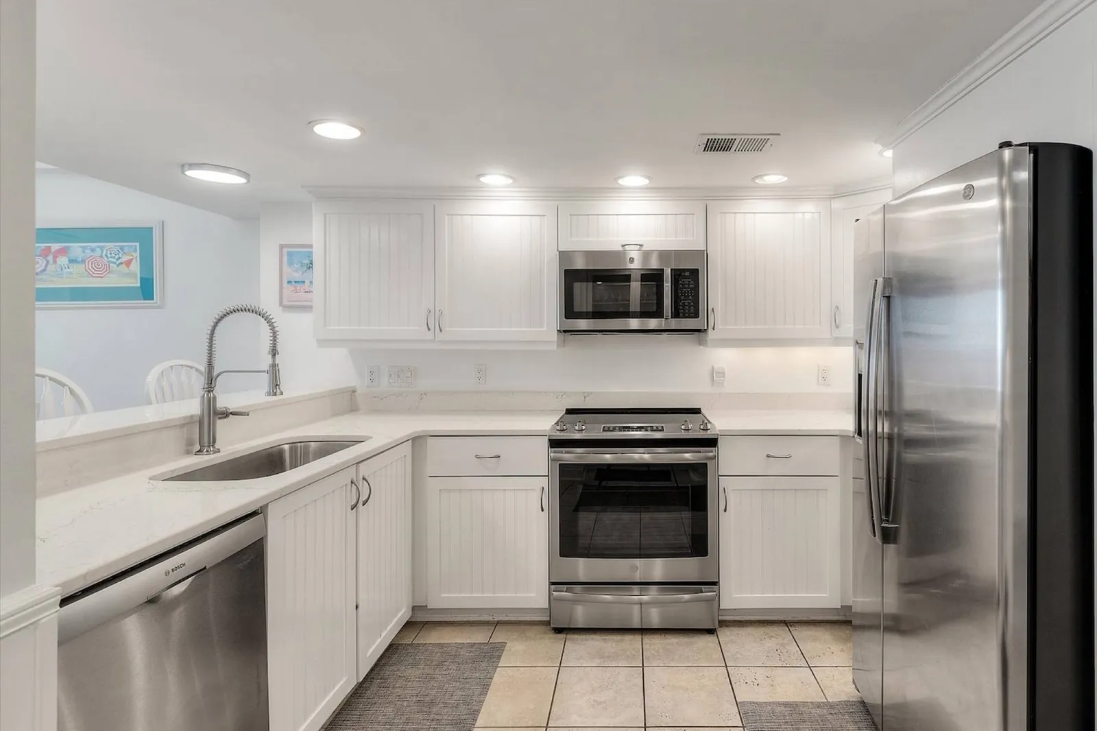 The kitchen has a refrigerator, range, microwave and dishwasher.