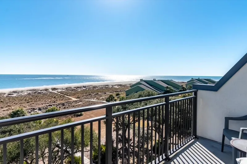 Step out onto the balcony off of the primary suite to enjoy these views.