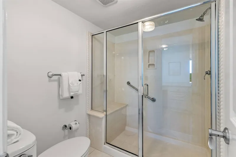 The en suite bathroom features a walk-in shower.