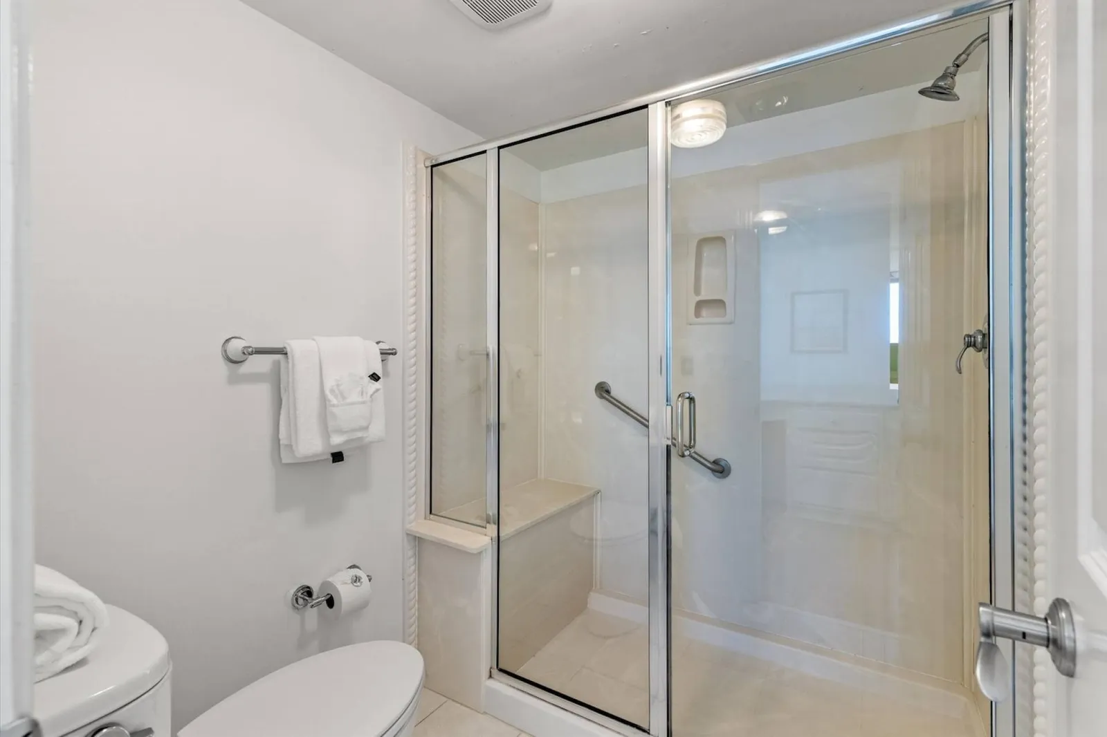 The en suite bathroom features a walk-in shower.