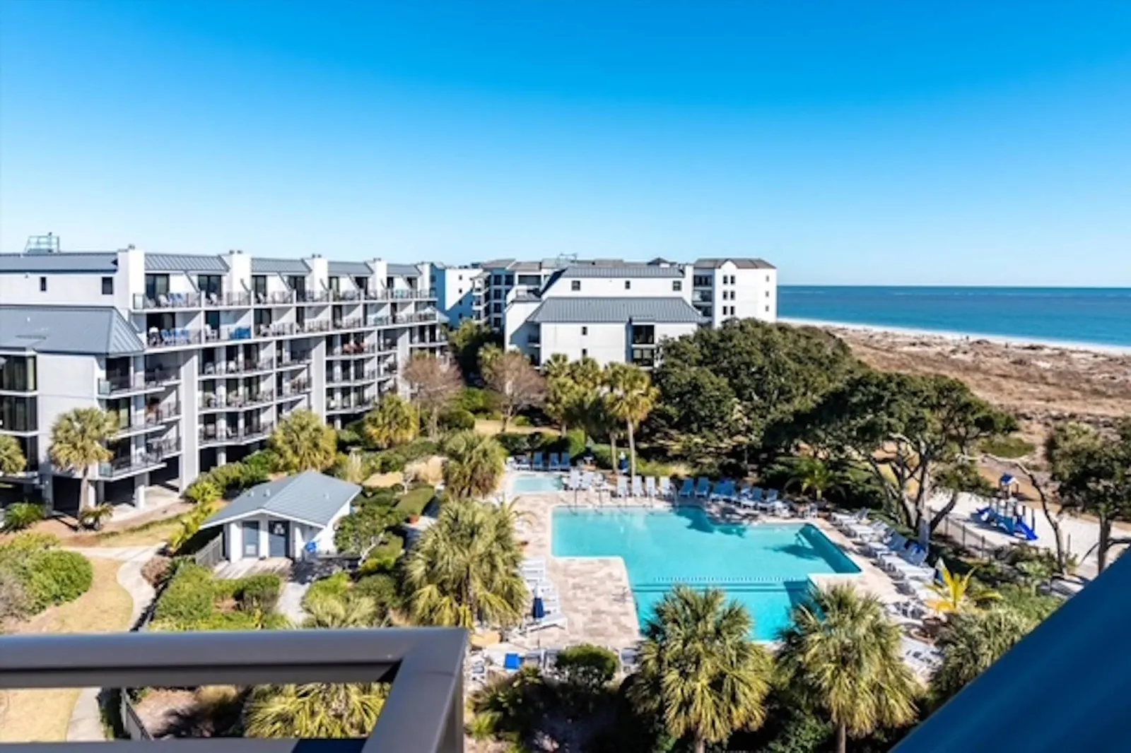 The roof deck patio also features a bird's eye view of the Shipwatch community pool below.