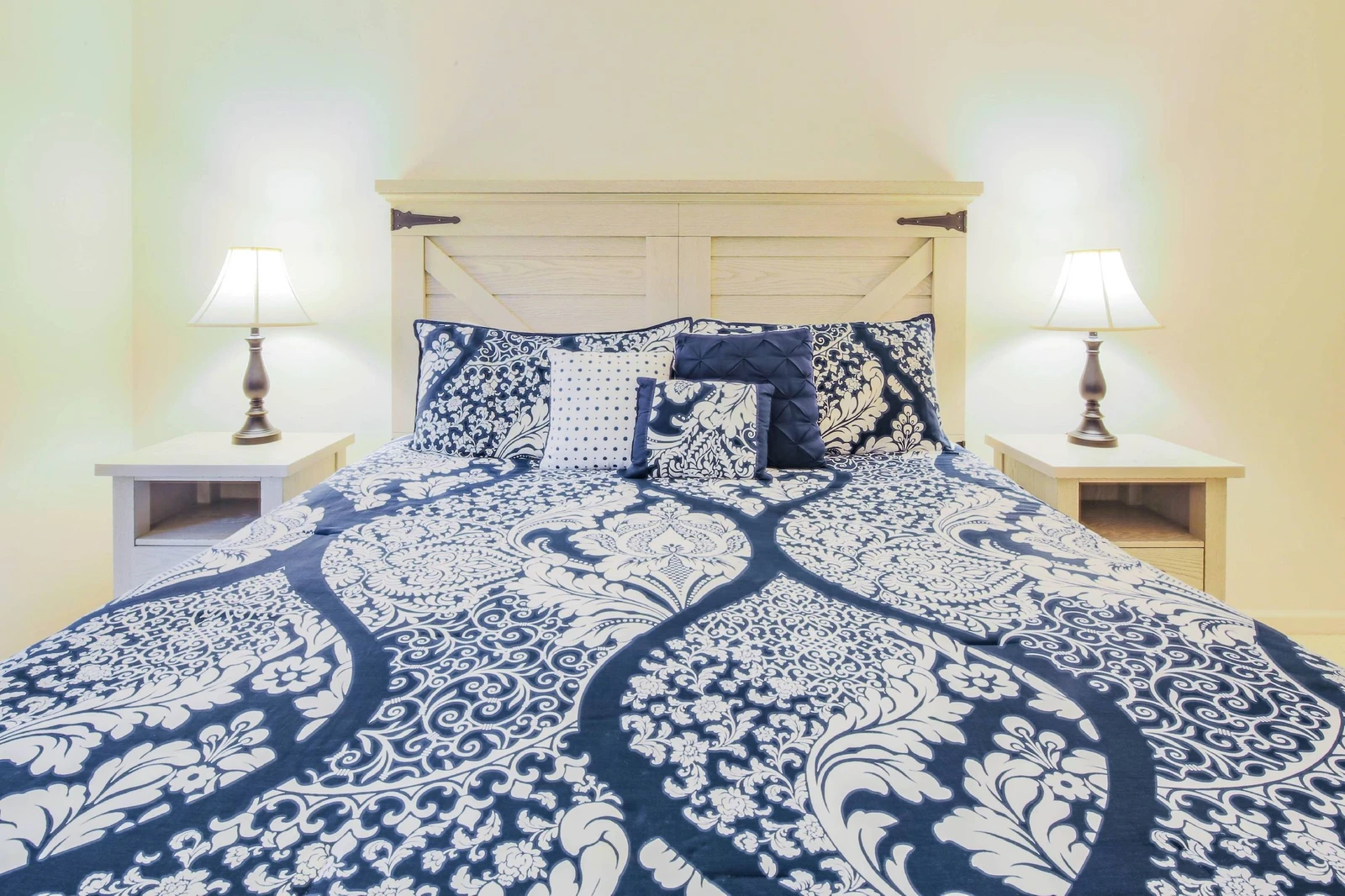 The king suite features a king bed and night stands with reading lamps.