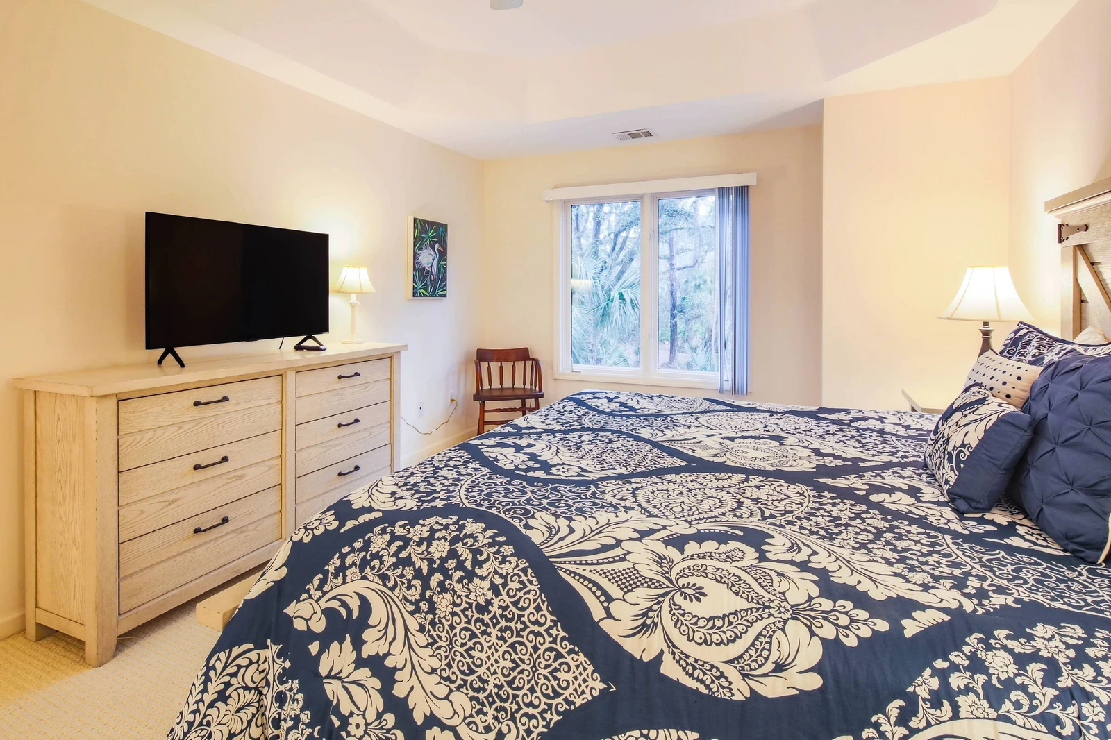The king suite also features a dresser, smart TV and a chair.
