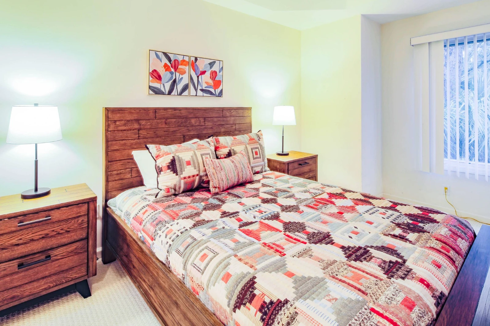 The queen suite features a queen bed and night stands with reading lamps.