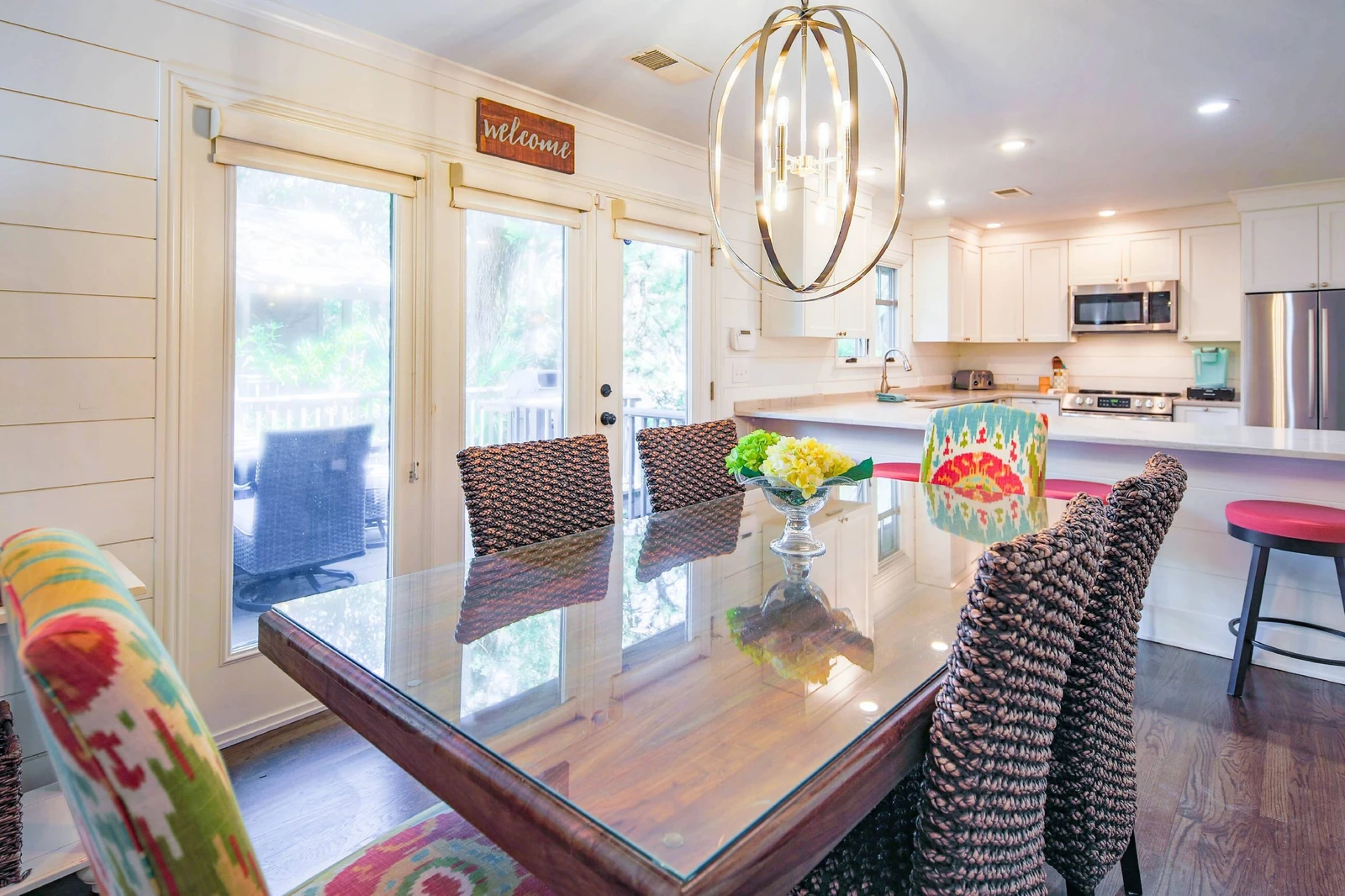 Step out from the dining area onto the deck alongside this beach home.