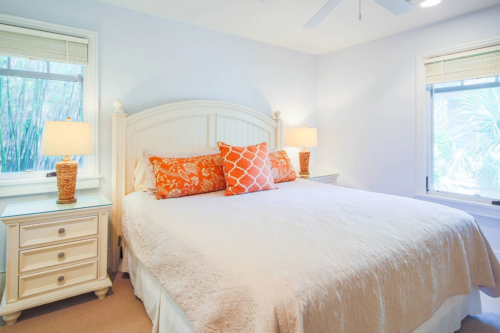 The primary suite features a king bed and night stands with reading lamps.