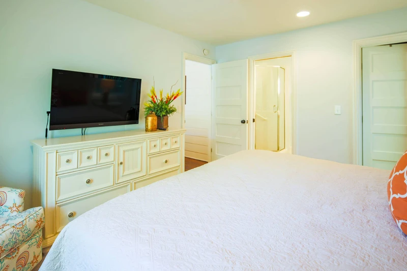 The en suite bathroom is located through the door next to the bedroom door.