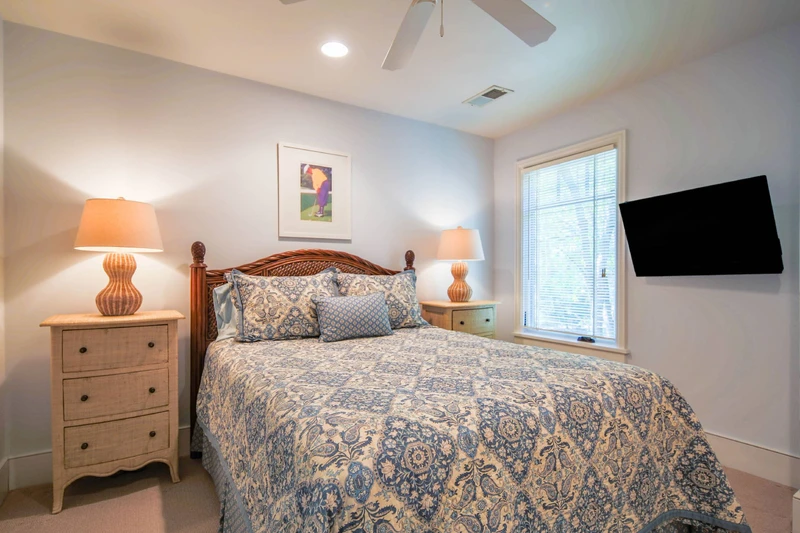 The queen bedroom features a queen bed with night stands and reading lamps.