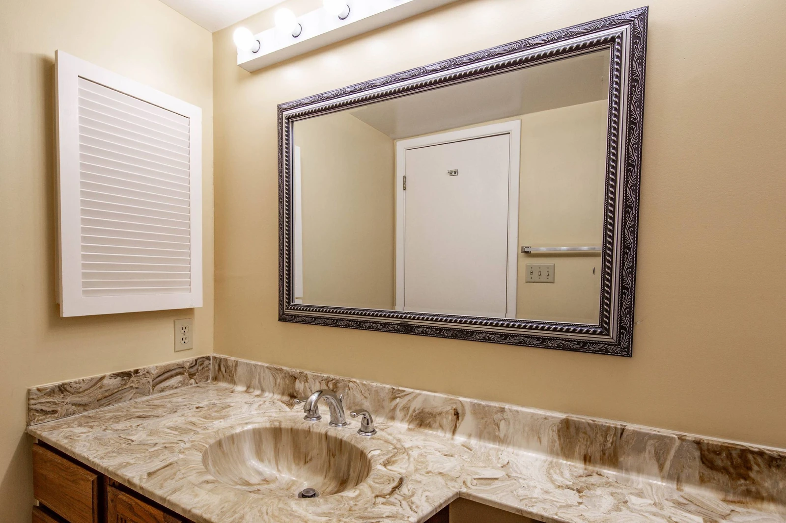 The hallway bathroom features a spacious vanity and medicine cabinet.