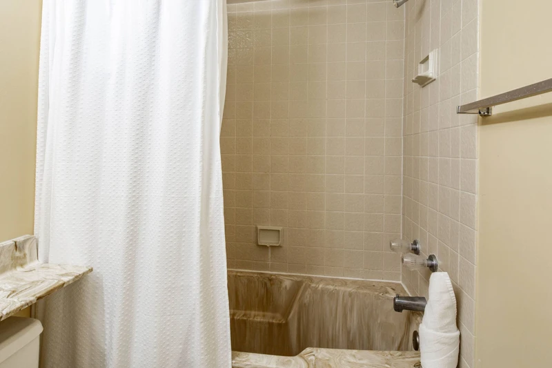 The hallway bathroom also features a shower/tub combo.