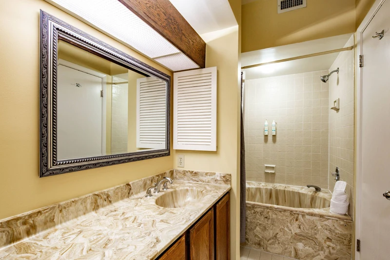 The en suite bathroom features a spacious vanity.