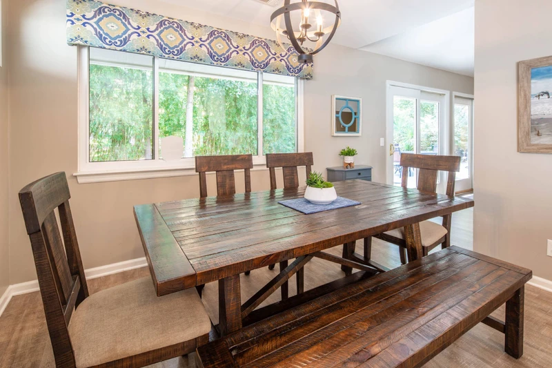 The dining area receives lovely natural light through the windows and doors along the backside of the home.