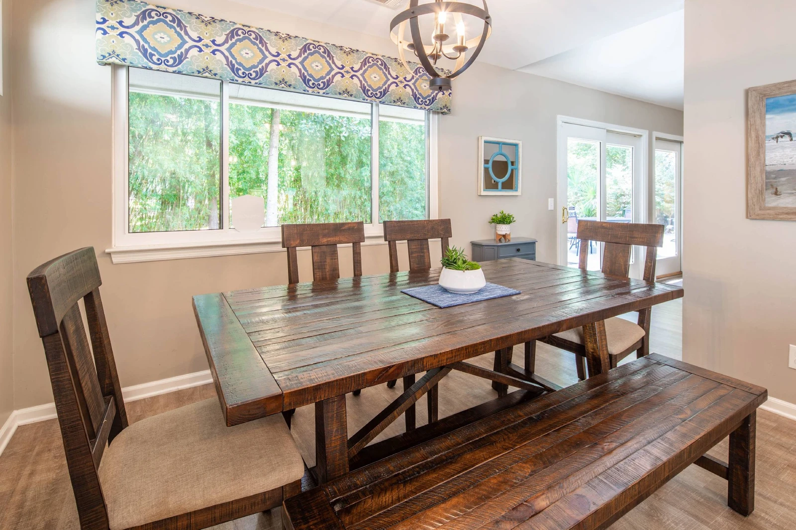 The dining area receives lovely natural light through the windows and doors along the backside of the home.