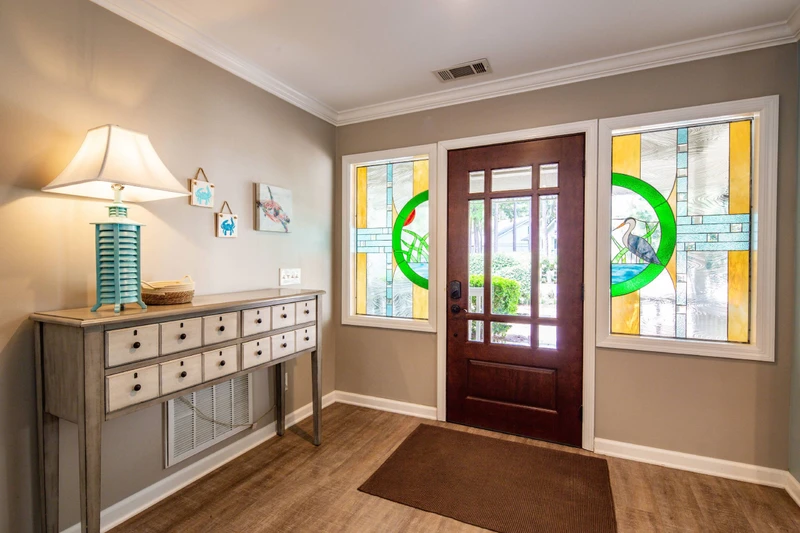 Step inside the front door to find this bright entryway with stained glass windows.