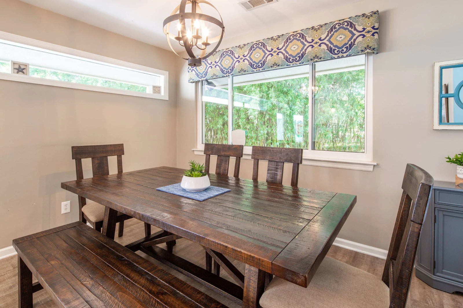 The dining table comfortably seats 6 people.  There are 4 stools at the kitchen counter.