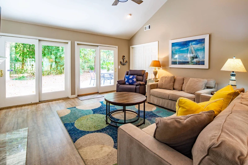 The living room features a spacious seating area and sliding door access to the back deck & patio.