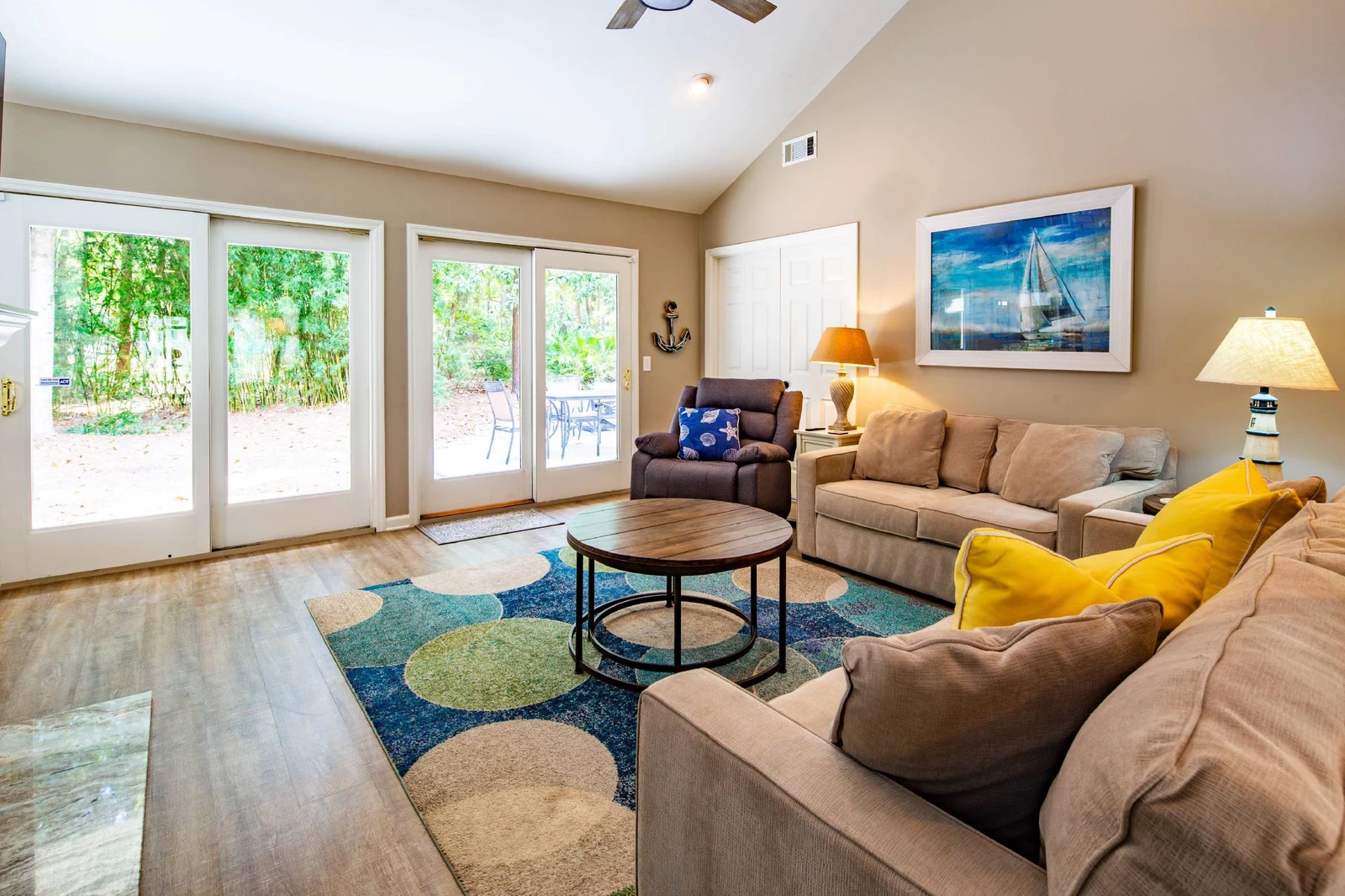 The living room features a spacious seating area and sliding door access to the back deck & patio.