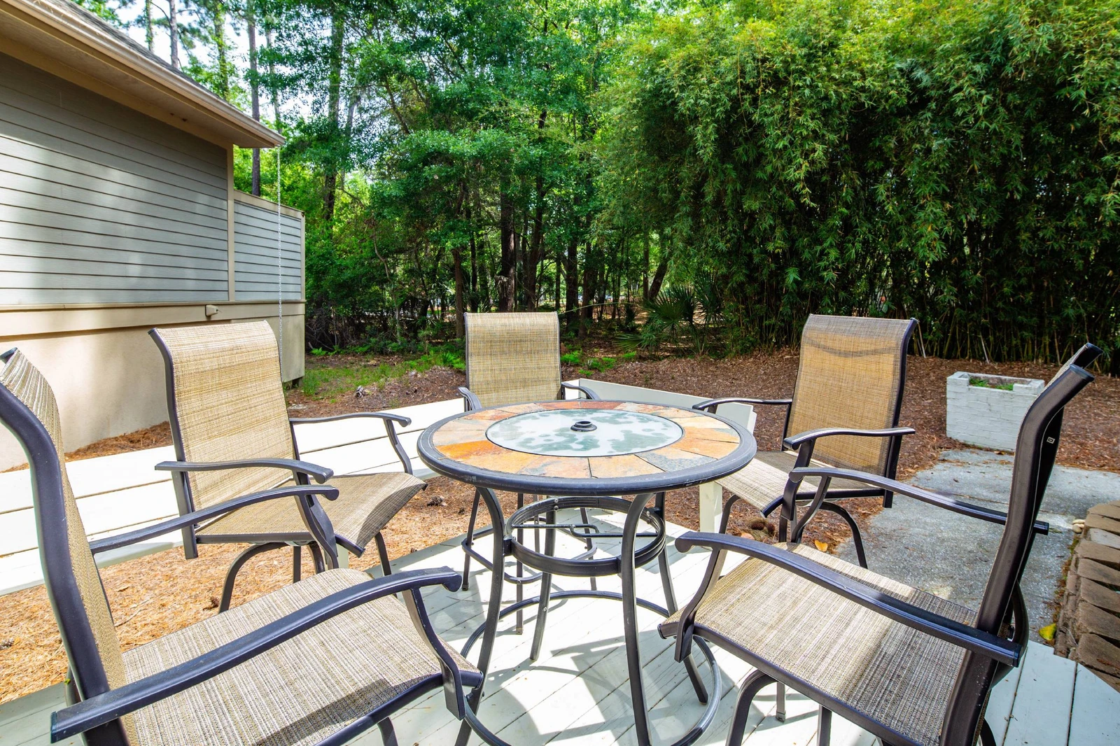 There is a high top table & chairs located on the side deck near the door to the kitchen.