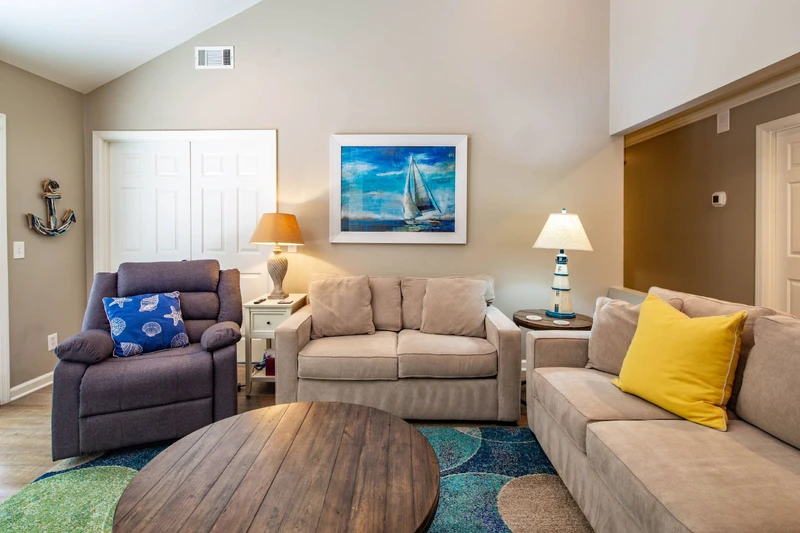 The living room features a sofa, love seat and reclining arm chair.