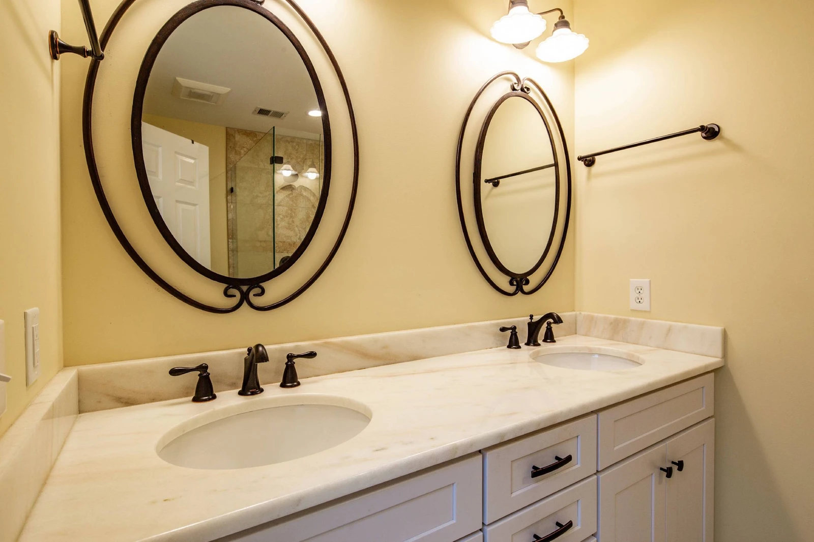 The primary en suite bathroom features a dual sink vanity.