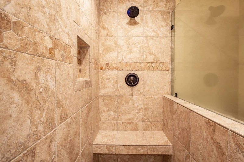 The primary en suite bathroom features a tiled, walk-in shower.