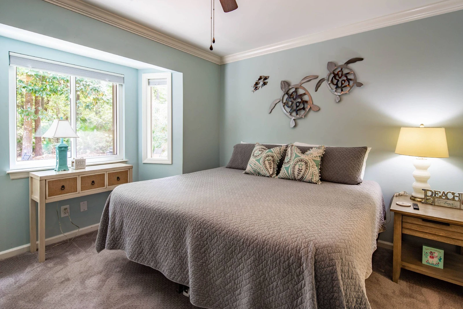 The king bedroom features a king bed, night stand with reading lamp and views of the back deck & patio.