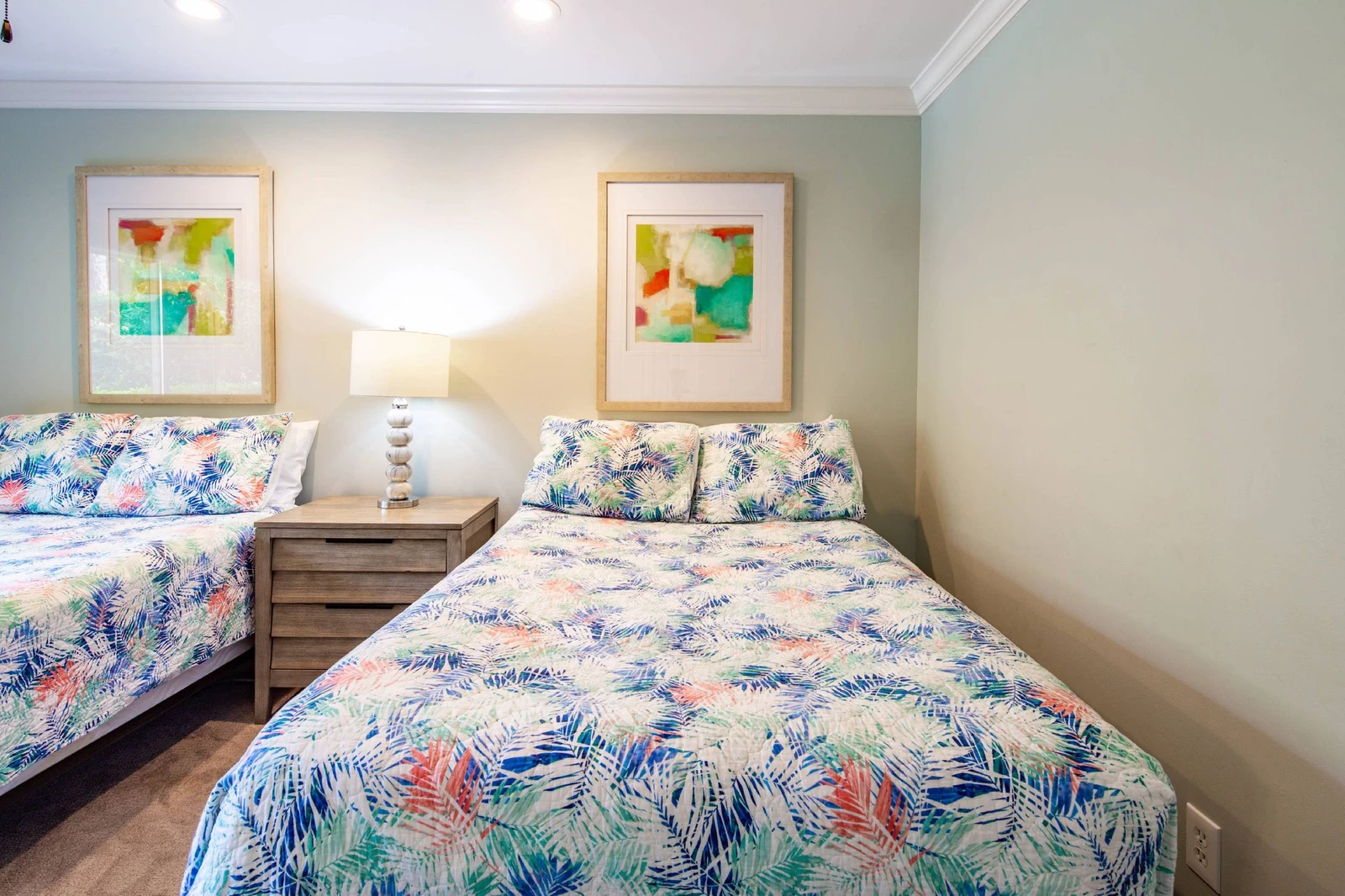 There is a night stand with a reading lamp that separates the two beds in the full suite.