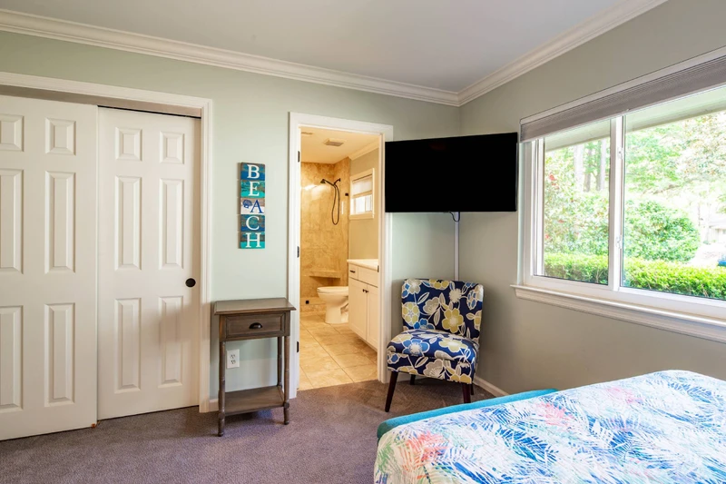 The full suite also has a closet, wall-mounted smart TV and an en suite bathroom.