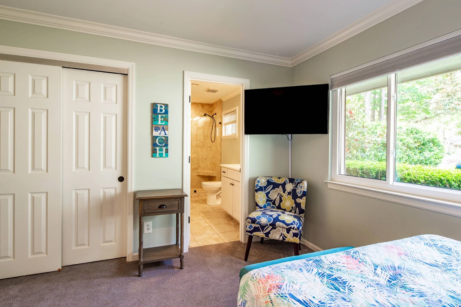 The full suite also has a closet, wall-mounted smart TV and an en suite bathroom.