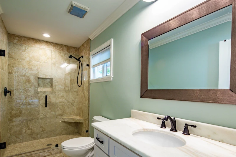 The en suite bathroom for the full suite features a vanity and tiled, walk-in shower.