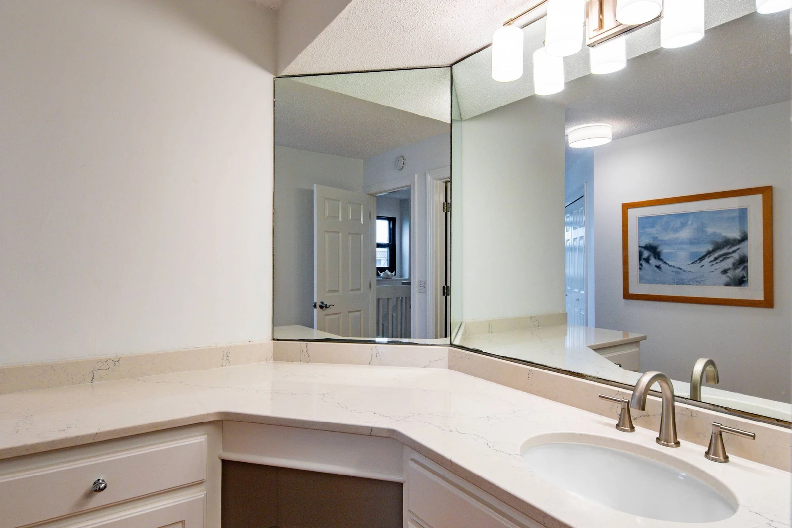 There is a spacious vanity with lots of storage area in the en suite bathroom.
