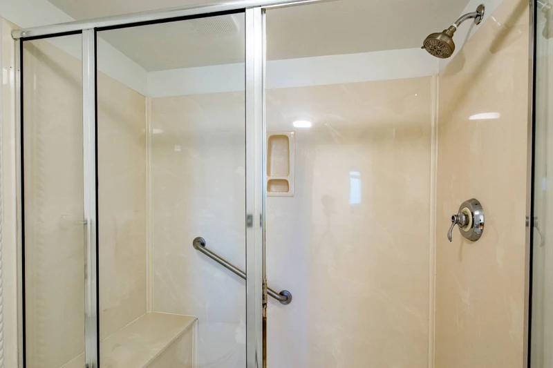 The en suite bathroom features a walk-in shower.