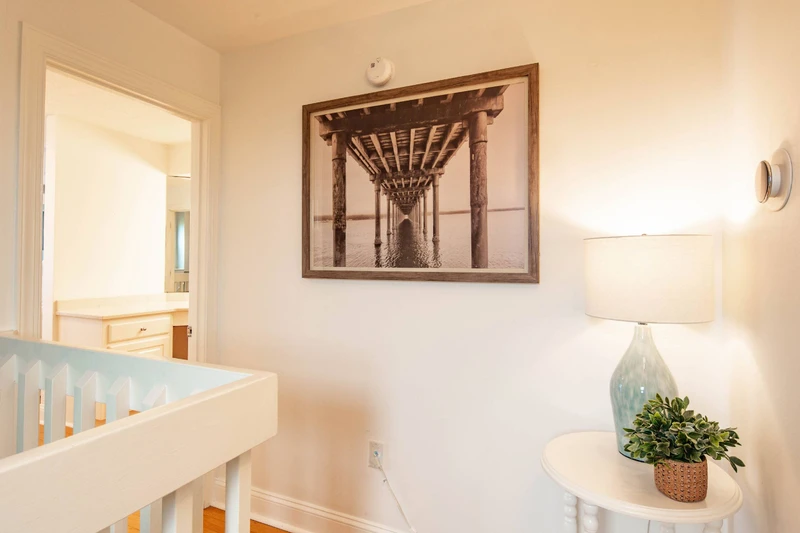 This hallway upstairs separates the primary suite from the guest suite.