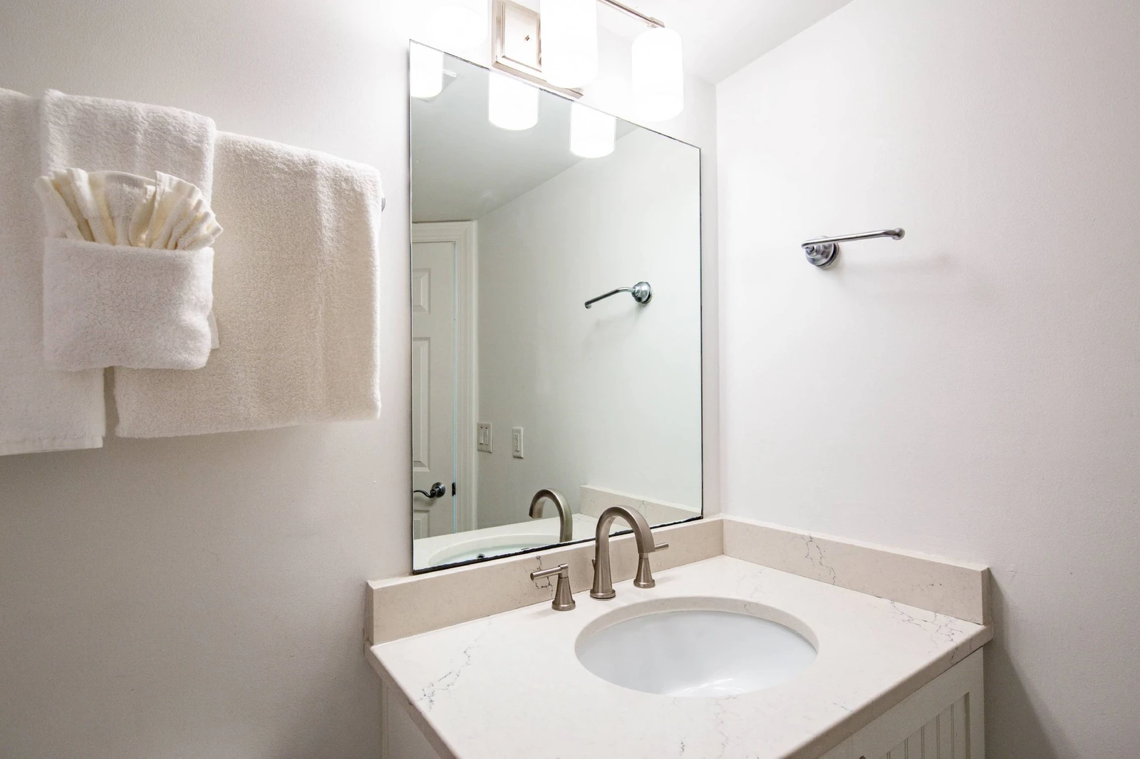 The en suite bathroom features a white vanity.