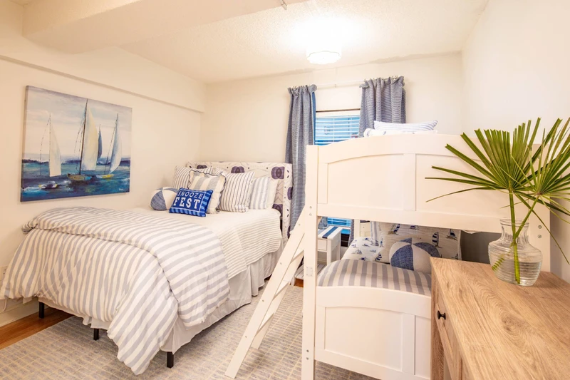 The guest bedroom features a queen bed and bunk bed (with two twin beds).