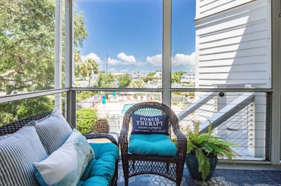 Step out onto the screened porch for these relaxing views of the communit pool and marina.