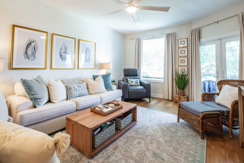 The living room receives lovely natural light through the window and doors to the screened porch.