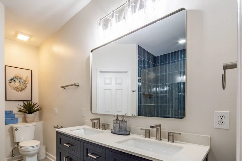 The primary en suite bathroom features this dual sink vanity.