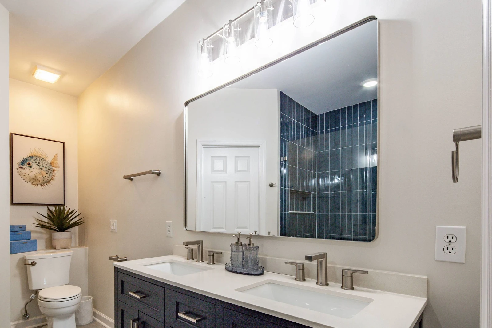 The primary en suite bathroom features this dual sink vanity.