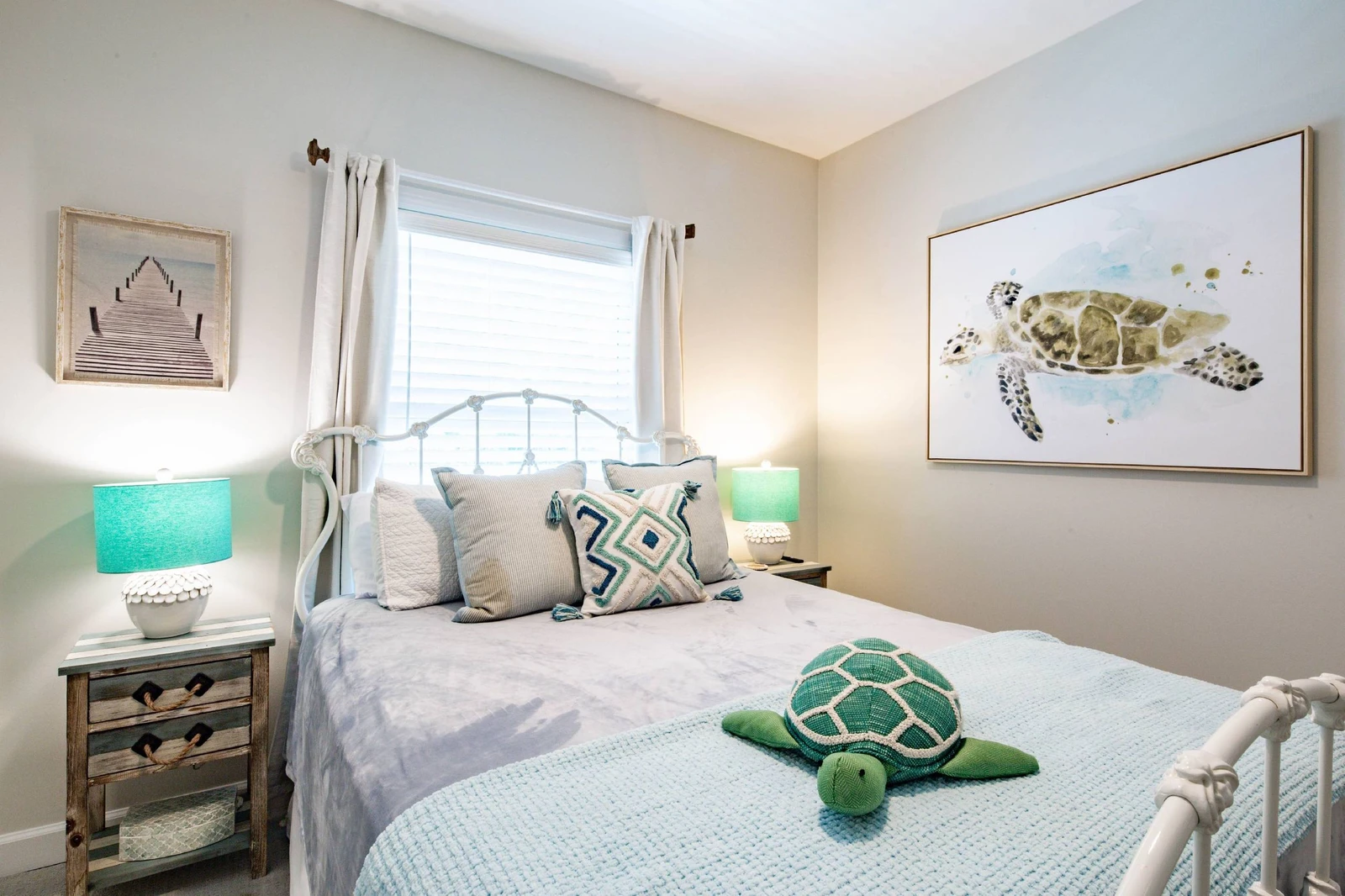 The guest bedroom features a queen bed with night stands and reading lamps.