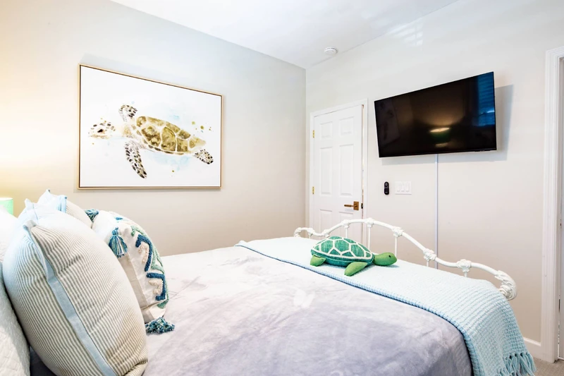 The guest bedroom also has a wall-mounted TV.