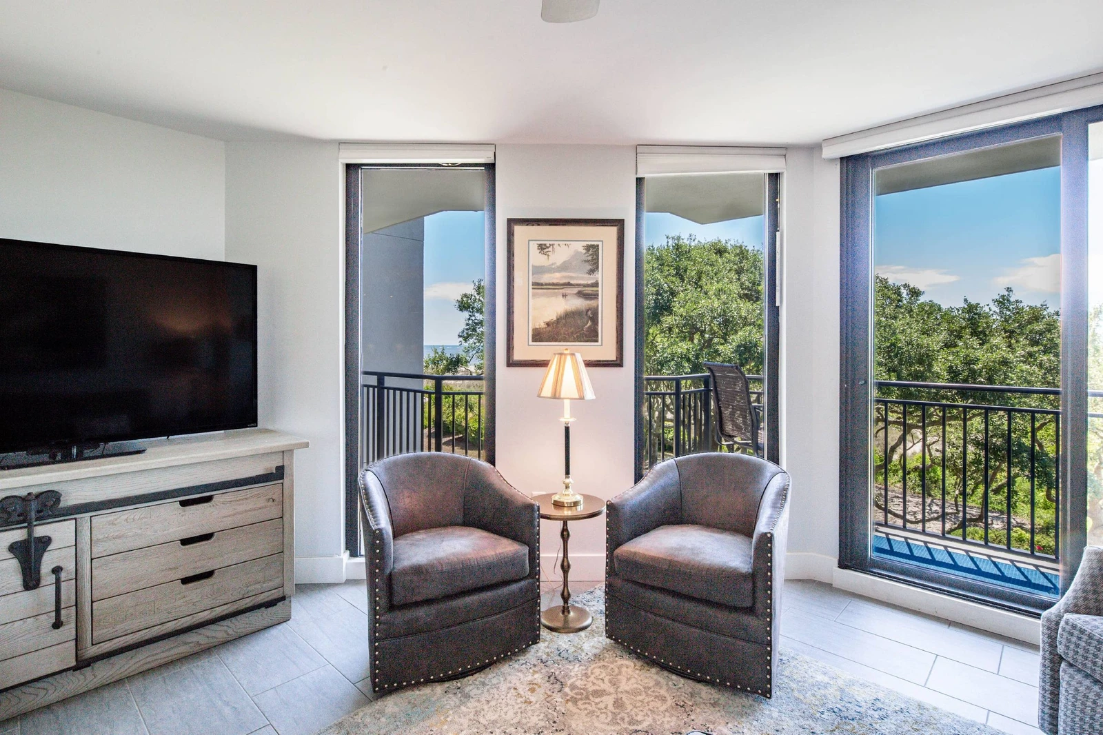 The living room features sliding door access to the private balcony.