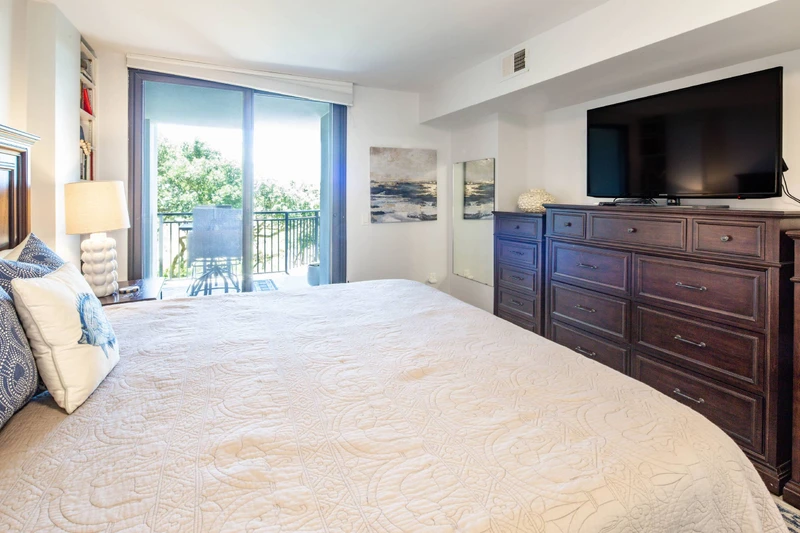 The primary suite also featuers a dresser and flat screen TV.