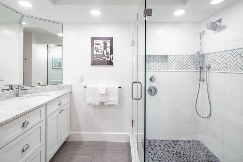 The primary en suite bathroom features a spacious vanity and a tiled, walk-in shower.