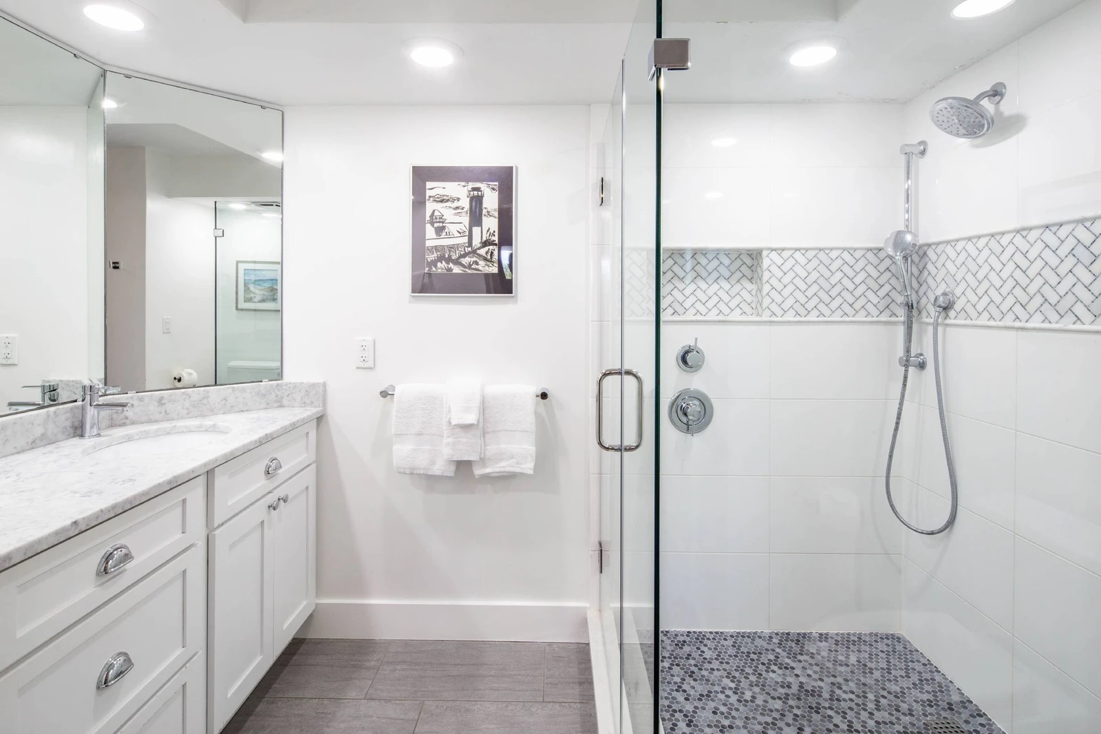 The primary en suite bathroom features a spacious vanity and a tiled, walk-in shower.