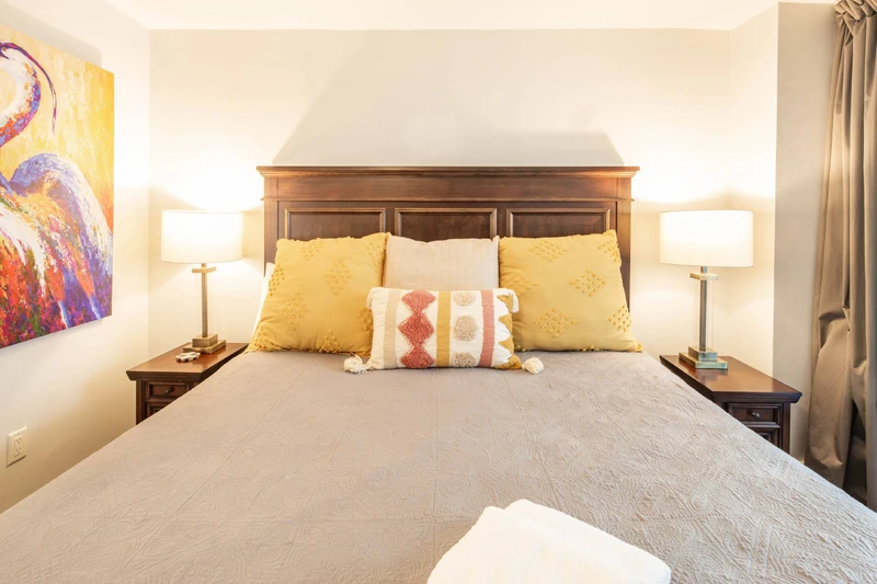 The king suite features a king bed and night stands with reading lamps.