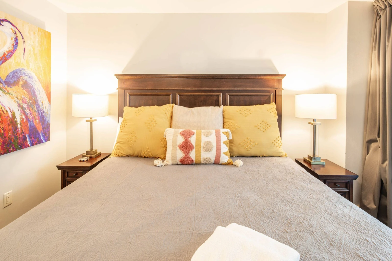 The king suite features a king bed and night stands with reading lamps.