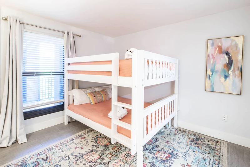 The bunk suite features a queen bed on the bottom bunk and a queen bed on the top bunk.