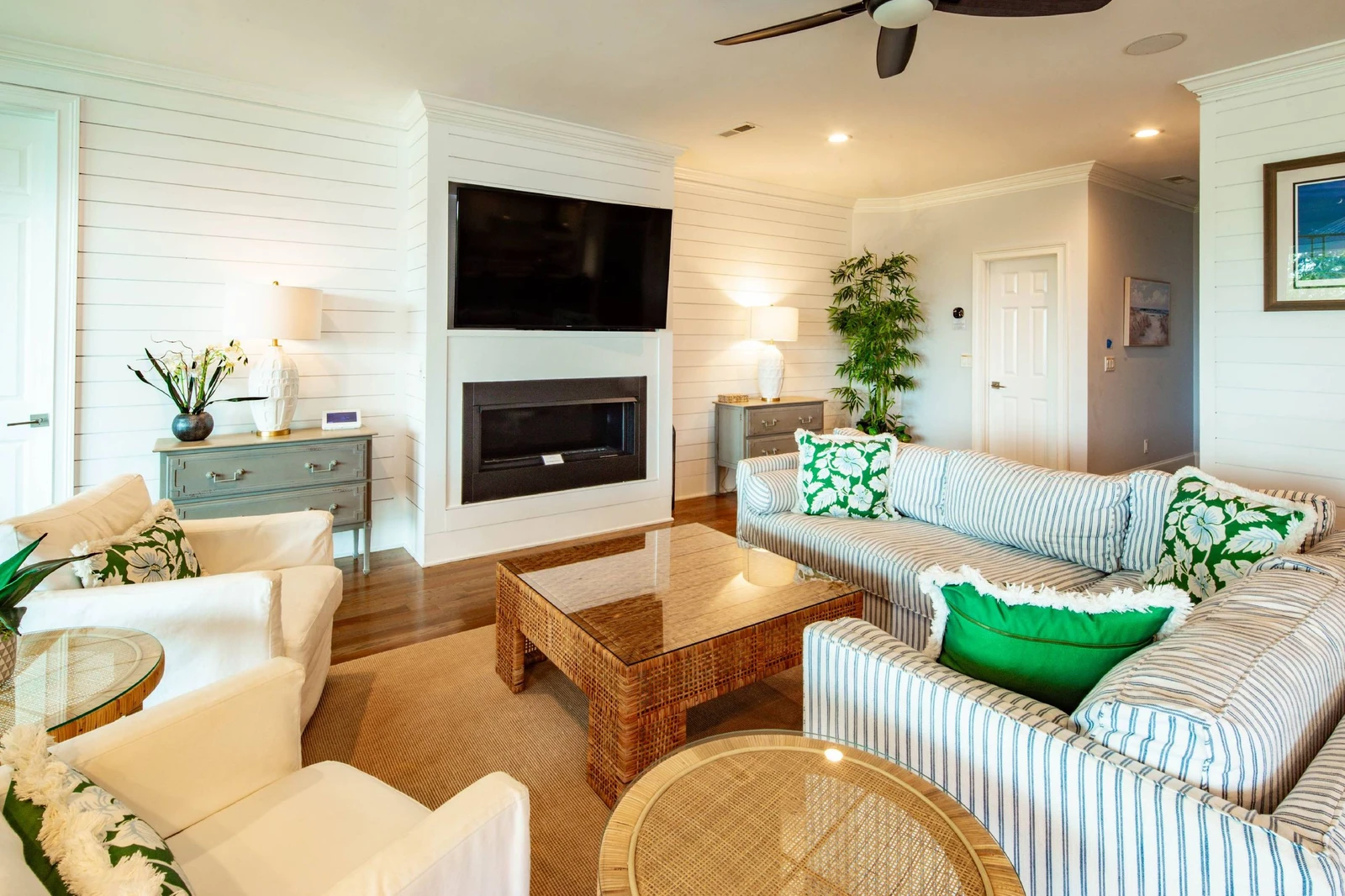 You'll find the living room with shiplap walls and mounted large screen TV on the second level of the home.