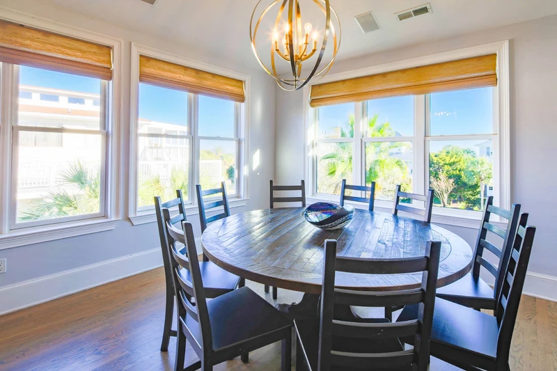 The dining table seats 10 and there are additional stools at the kitchen counter.